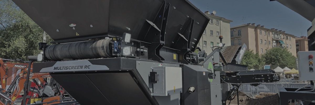 Tracked mobile crusher with the control panel mounted on the side of the machine.